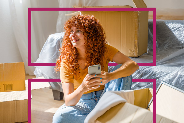 Personne entourée de cartons de déménagement, préparant son installation dans un nouveau logement